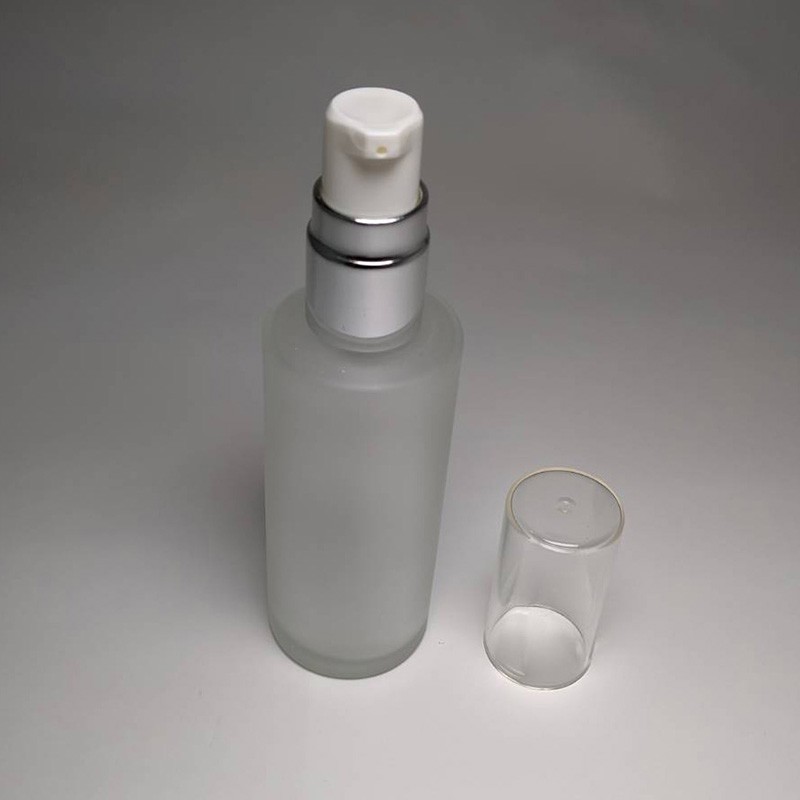 Best seller 50ml empty cylinder shape glass bottle with 18/415 neck size white actuator lotion pump and oversize cap for facial lotion